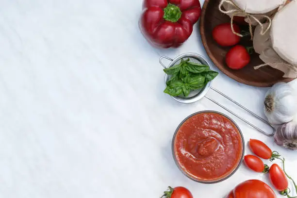 Italian tomato sauce with basil, tomatoes, pepper and garlic. Top view, flat lay. Copy space.