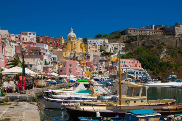 Morning aerial view of traditional fishing boats docked at the harbour of Ponza with colorful building in front of the harbour, Ponza island, Pontine archipelago, Tyrrhenian sea, Latina province, Latium, Italy, Europe