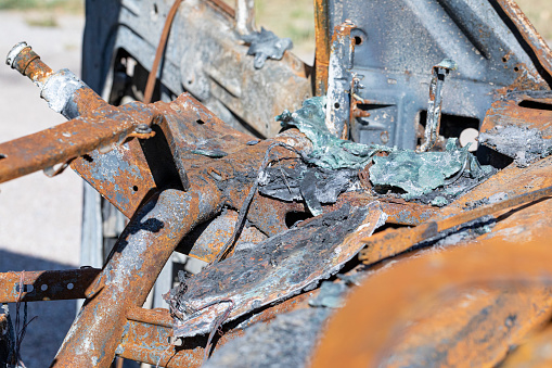 Burnt truck details, rusty pieces, melted glasses and plastics