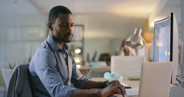 istock Software designer, engineer or businessman typing on laptop for information technology or cyber security. Computer, search or black man reading web design data for iot digital transformation at night 1690348006