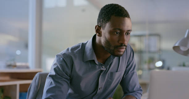 istock Software designer, search or businessman typing on laptop for information technology or cyber security. Computer, office or black man reading web design data for iot digital transformation at night 1690348013