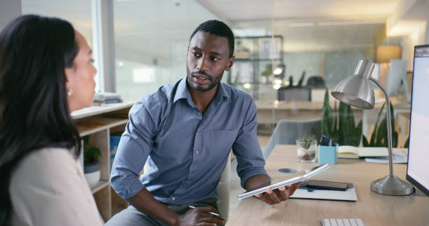 istock Software designer, teamwork or programmer talking to woman for information technology or cyber security. Computer, tablet or black man reading web design code for iot digital transformation in office 1690348539