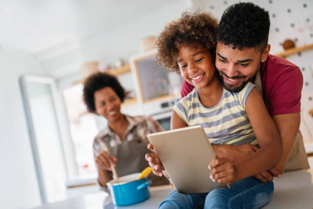 istock African family tablet and child learning at home with happiness, development, internet connection. 1690352304