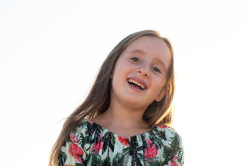 Portrait of a beautiful 5 or 6 year old girl against the sky, copy space for text.