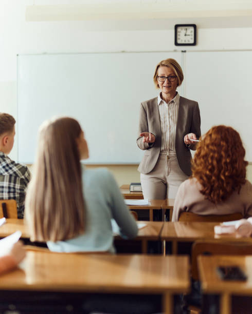 istock Mature female teacher giving a lecture at high school. 1690373621