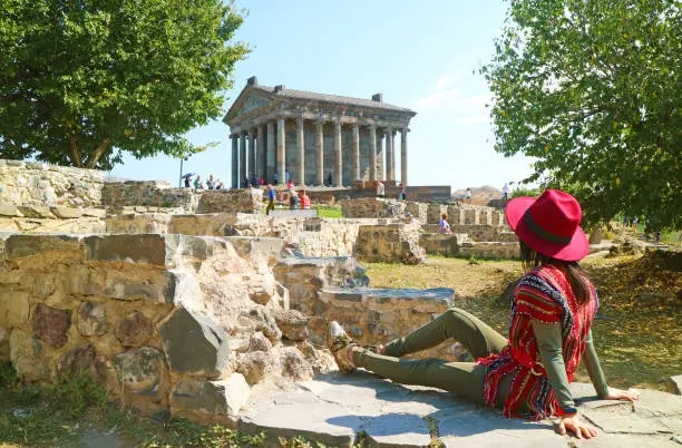 Photo of Female Visitor Enjoying Impressive View of the Ancient Garni Pagan Temple in Kotayk Province, Armenia