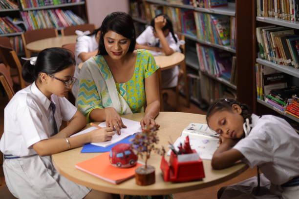 istock Student hard work girl child education teacher teaching, siting in library, thumbs up. 1690391478