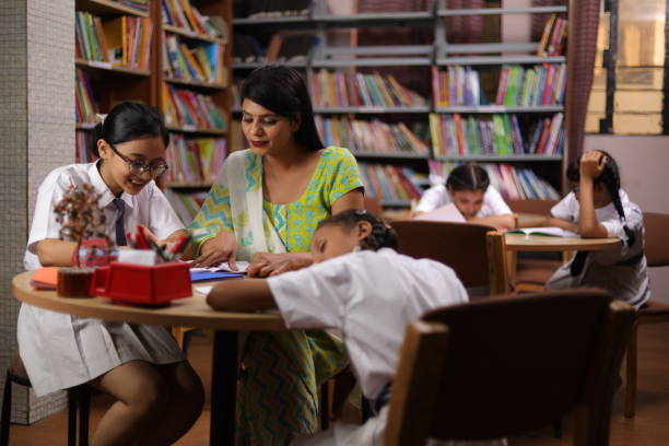 istock Student hard work girl child education teacher teaching, siting in library, thumbs up. 1690393677