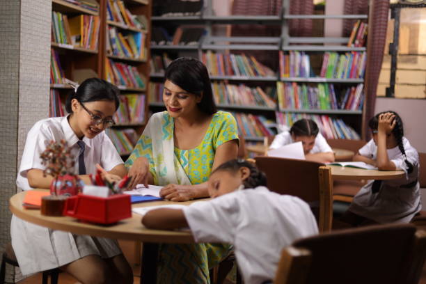 istock Student hard work girl child education teacher teaching, siting in library, thumbs up. 1690393679