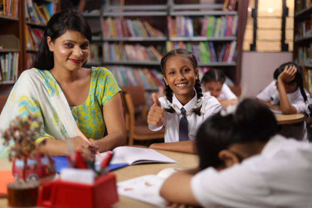 istock Student hard work girl child education teacher teaching, siting in library, thumbs up. 1690395295