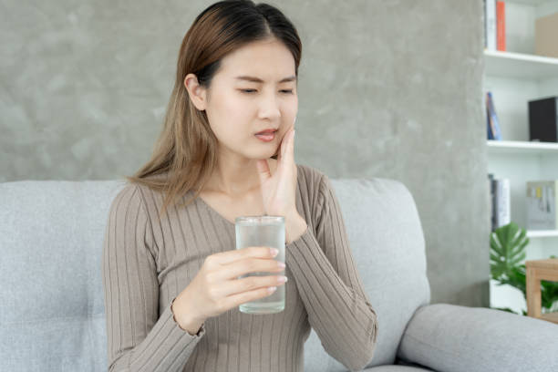 istock Asian woman feel sensitive teeth after drinking cold, female suffer tooth, decay problems, dental care, tooth extraction, decay problem, bad breath, Gingival Recession, Oral Hygiene instruction 1690396231