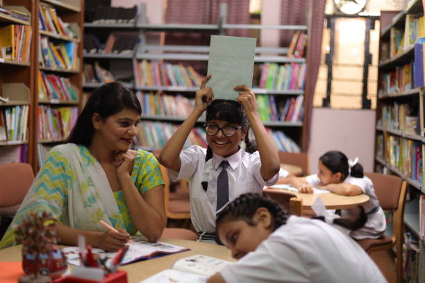 School teacher teaching one student and four students sleeping in library, nerd, topper, extra classes.