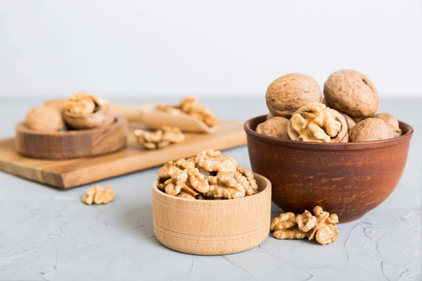 istock Fresh healthy walnuts in bowl on colored table background. Top view Healthy eating bertholletia concept. Super foods 1690408698