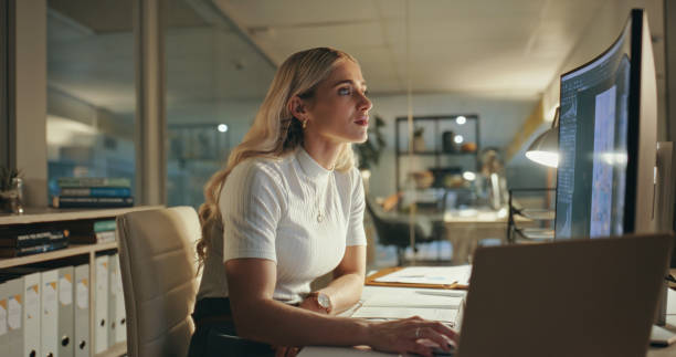 istock Night, business woman and designer on computer in office at table working on deadline. Creative, pc and serious professional focus at desk, reading email or editing software project online in startup 1690410355