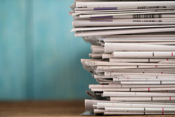 istock close up newspapers folded and stacked background on the table with green background. 1690415604