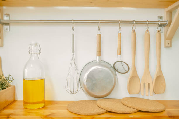 istock Wooden Kitchen Utensils hanging on white concrete background 1690477425