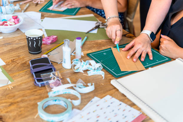 istock Scrapbook workshop. Colleagues helping each other. Companionship concept 1690493970