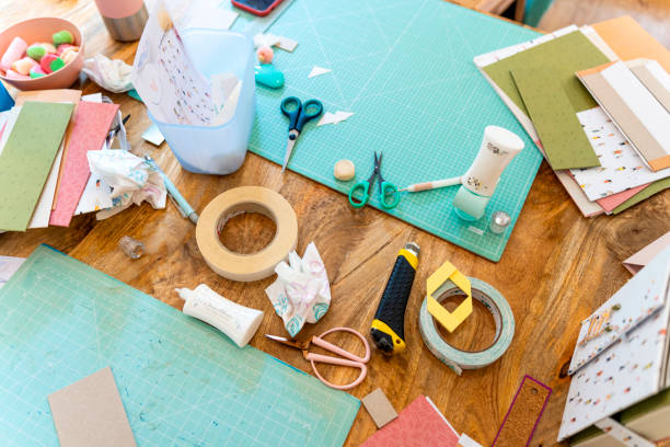 istock Scrapbook workshop. Cutting table with all types of scissors and adhesives 1690494049