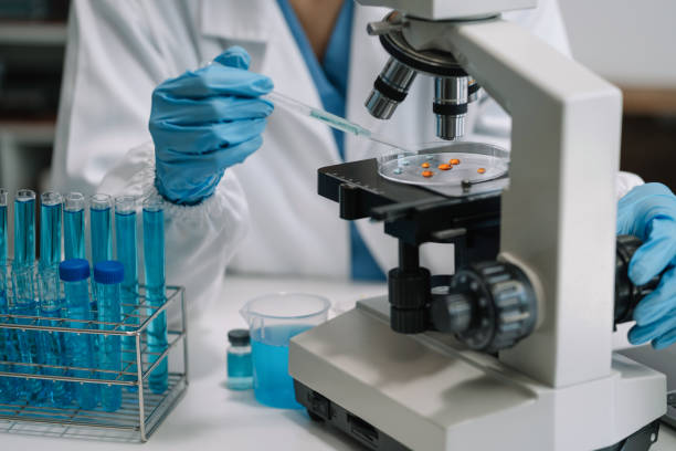 istock Science and medicine, scientist analyzing and dropping a sample into a glassware, experiments containing chemical liquid in laboratory on glassware, innovative and technology. 1690505052
