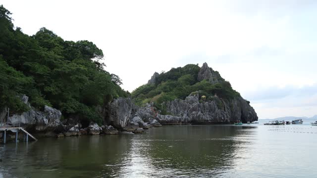 Landscape of limestone mountains amidst the peaceful blue sea, Nghe island, Kien Giang province