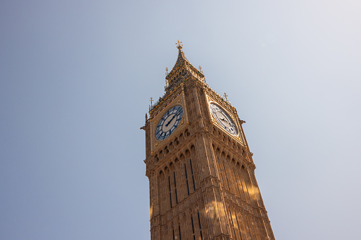 Big Ben Clock Tower in London, UK, on a bright day. Panoramic composition with text space on blue sky
