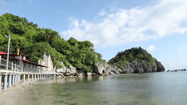 Landscape of limestone mountains amidst the peaceful blue sea, Nghe island, Kien Giang province