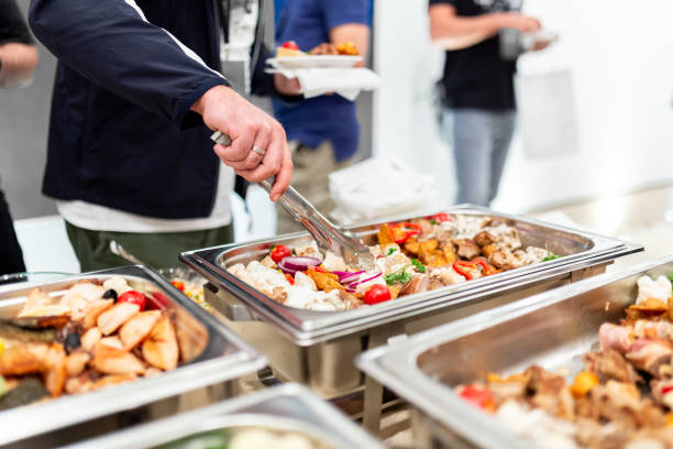 istock People choosing fresh prepared food from buffet table. 1690578745
