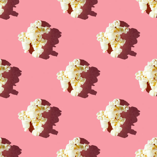 istock seamless pattern of single popcorn on a pink background with hard light 1690593817