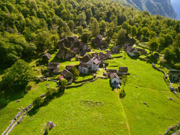 istock Summertime in an ancient town with stone houses and a waterfall 1690647112