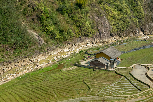 Traditional Vietnamese-style farmhouse at the foot of rice terraces. Mountain area in northern Vietnam, near Sapa