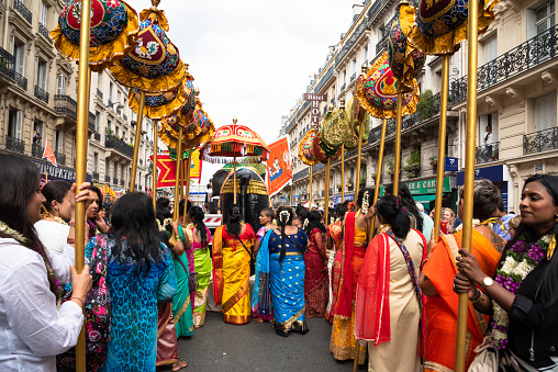 Paris, France - August 27, 2023: Women in colorful sari at traditional street procession during festival of the god Ganesh. The Hindu and Tamil community celebrates birthday of god-elephant Ganesh.