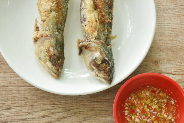 istock crispy fried fresh mackerel fish dipping spicy chili sauce in cup 1690705633