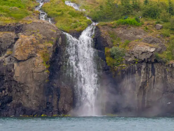 Photo of Waterfall on the cliffs of the the ÃsafjÃ¶rÃ°ur (ice fjord, VestfirÃ°ir (Westfjords), northwest of Iceland.