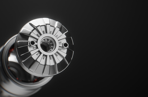 A conceptual electric car motor on dark gradient background, created in 3D. Close-up of an electric engine and its different parts.