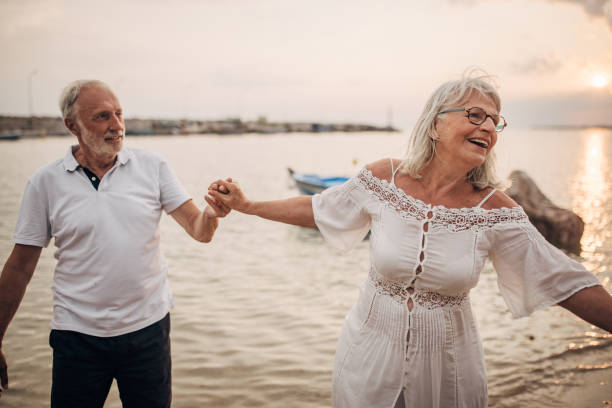 istock Senior couple dancing by the sea 1690724545