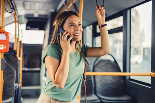 istock Attractive female passenger using mobile phone while commuting by public transport. 1690745314