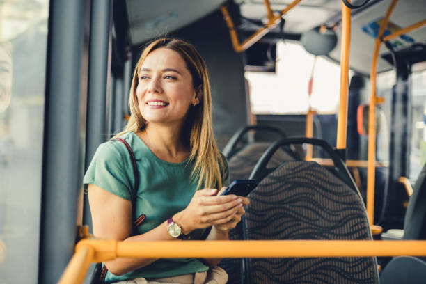 istock Attractive female passenger using mobile phone while commuting by public transport. 1690748678