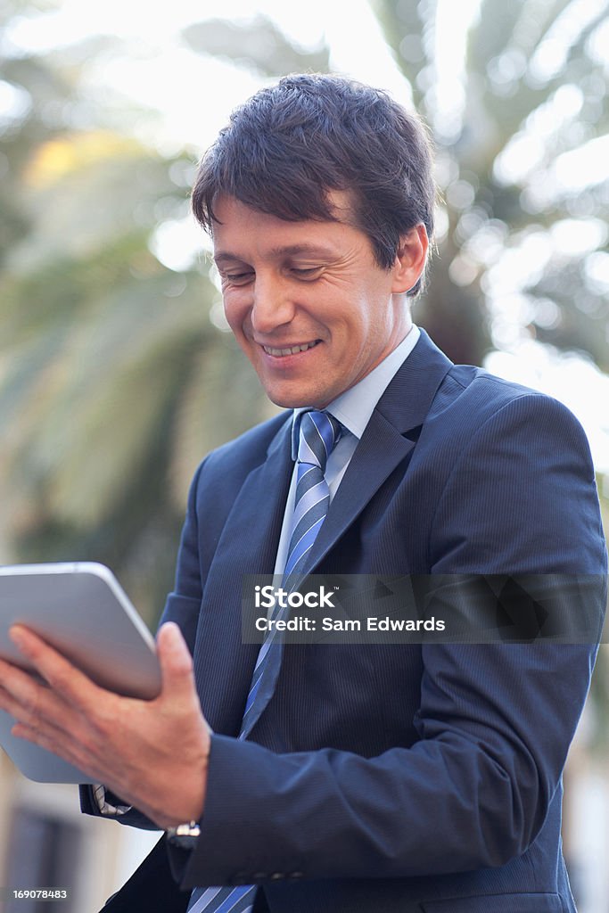 Businessman using digital tablet outdoors  30-39 Years Stock Photo