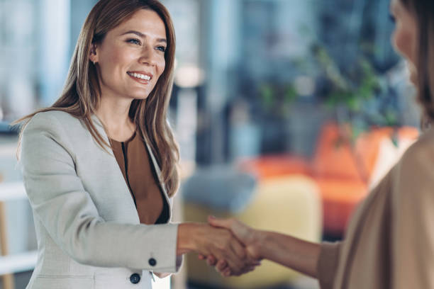 istock Businesswoman greeting a colleague 1690797009