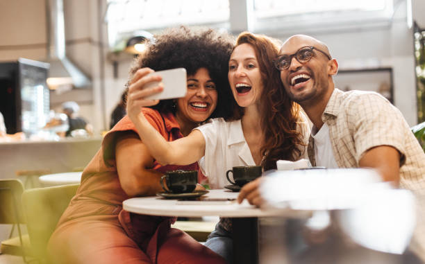 istock Three happy friends having fun and creating memories with selfies 1690797539