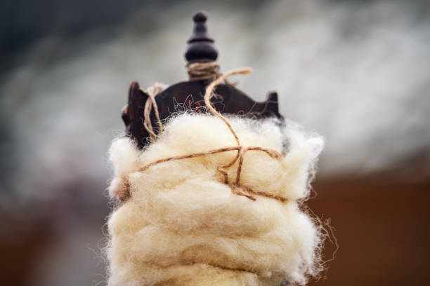 The spinning process involves twisting the fibers of the wool together to create a strong and durable thread for various textile applications.