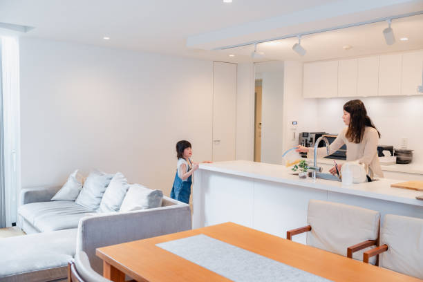 istock Mother talking with her child while doing chores in the kitchen 1690827375