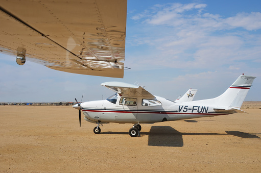 Swakopmund Namibia - Jan 31 2016: Cessna 210 Centurion airplane on the small airport near Swakopmund. Popular tourist attraction in Namibia - flight safaris above Namib desert
