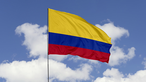 3d illustration flag of Colombia. Colombia flag isolated on the blue sky.