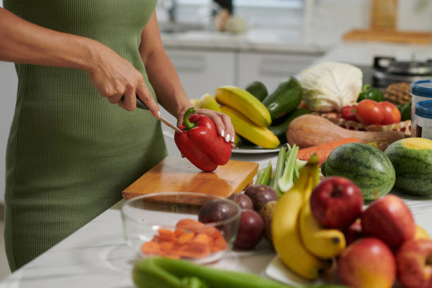 istock Woman Cutting Bell Pepper 1690843038