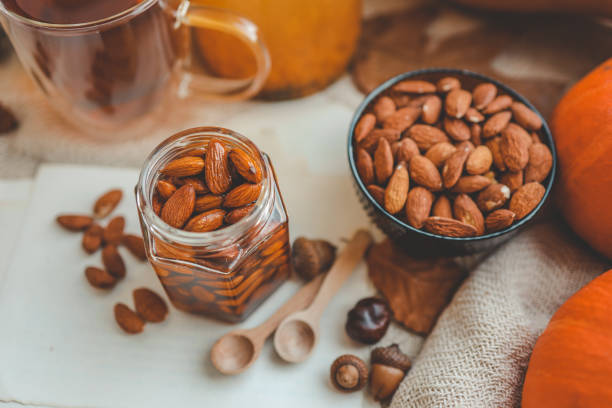Jar with craft sweet honey and nuts in autumn interior