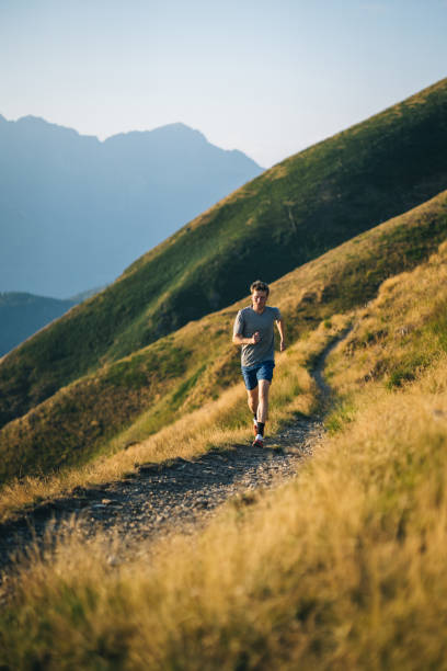 istock Trail runner bounds along mountain trail 1690850387