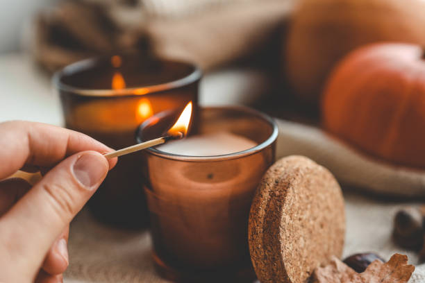 istock Match in hand lights a candle, cosiness concept 1690850918