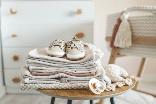 istock A stack of children's things on a wooden table in a children's interior 1690850930