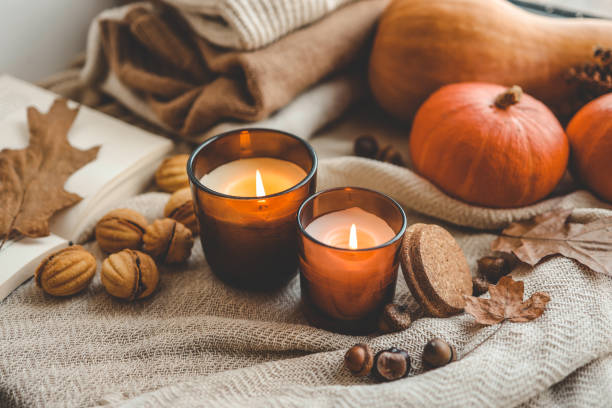 istock Two burning candles in the autumn interior 1690850935